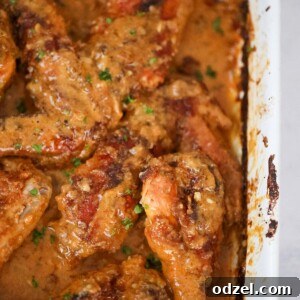Smothered turkey wings and legs in a baking dish up close.
