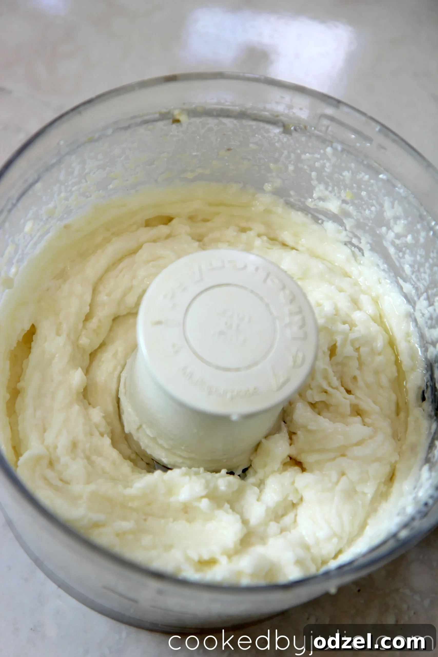 Creamy Lebanese Garlic Toum 3 This Lebanese garlic sauce comes together in just a quick 5 minutes in the food processor, shown in a process shot.