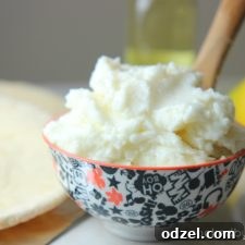 Creamy Lebanese Garlic Toum 5 Lebanese Traditional Toum in a serving bowl with a small spoon