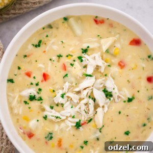 A bowl of creamy crab and corn bisque, garnished with fresh herbs, ready to be enjoyed.