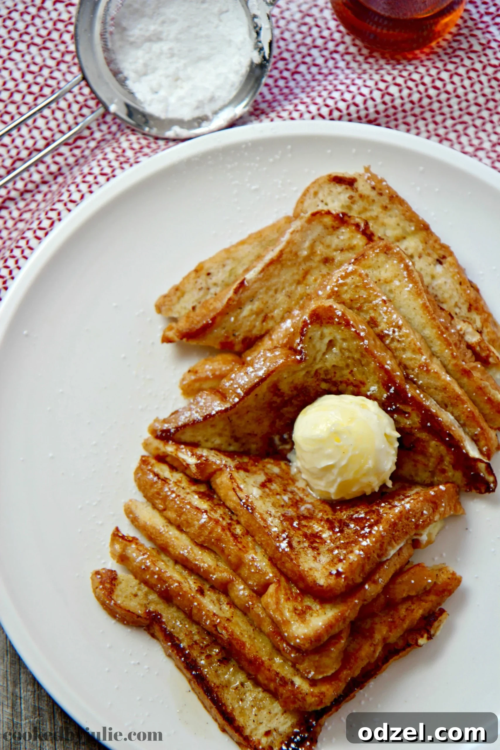 Golden French Toast Delights 2 Easy French Toast served with softened butter, powdered sugar, and warm maple syrup.