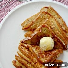 Easy French Toast served with softened butter, powdered sugar, and warm maple syrup.