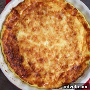 A delicious ham and Gruyere cheese crustless quiche presented in a 9-inch baking dish.