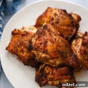 roasted chicken thighs on a white plate.