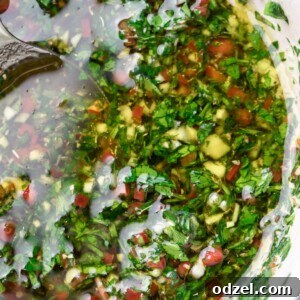 chimichurri in a white bowl up close.