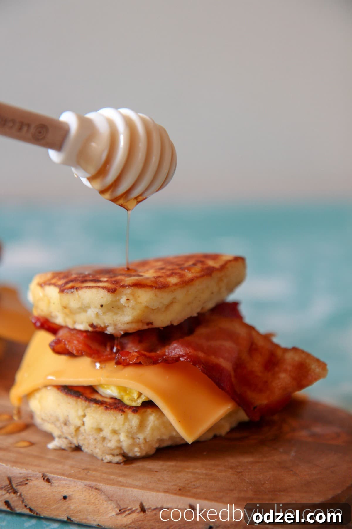 Gourmet Griddle Breakfast Sandwich 4 A single homemade Keto McGriddle Sandwich featuring syrup-infused pancakes, crispy bacon, fried egg, and melted cheese, ready to be enjoyed.