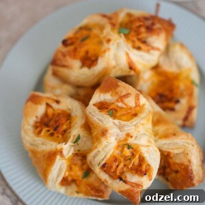 BBQ chicken pastry puffs on a plate with ranch on the side.