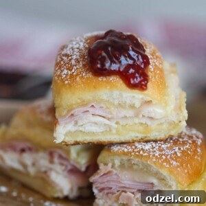Three monte cristo sliders on a cutting board.