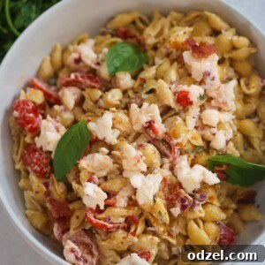 Lobster pasta salad with fresh basil on top.