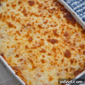A dish of ravioli lasagna with meat sauce and cheese.