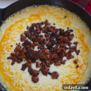 queso fundido in a cast iron skillet.