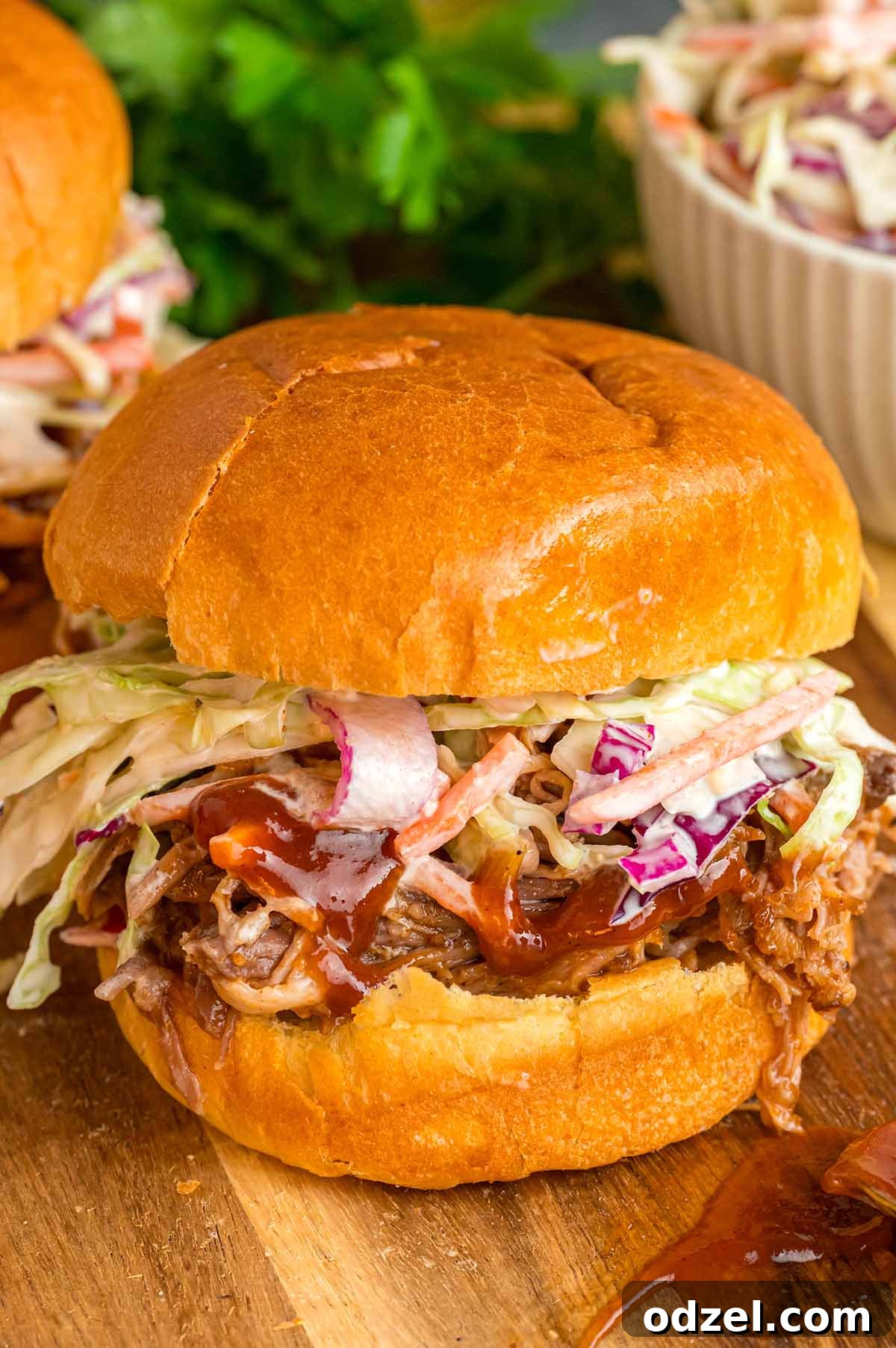 Delicious pulled pork sandwich stacked high with creamy coleslaw.