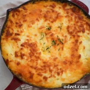 Cottage pie in a red skillet.
