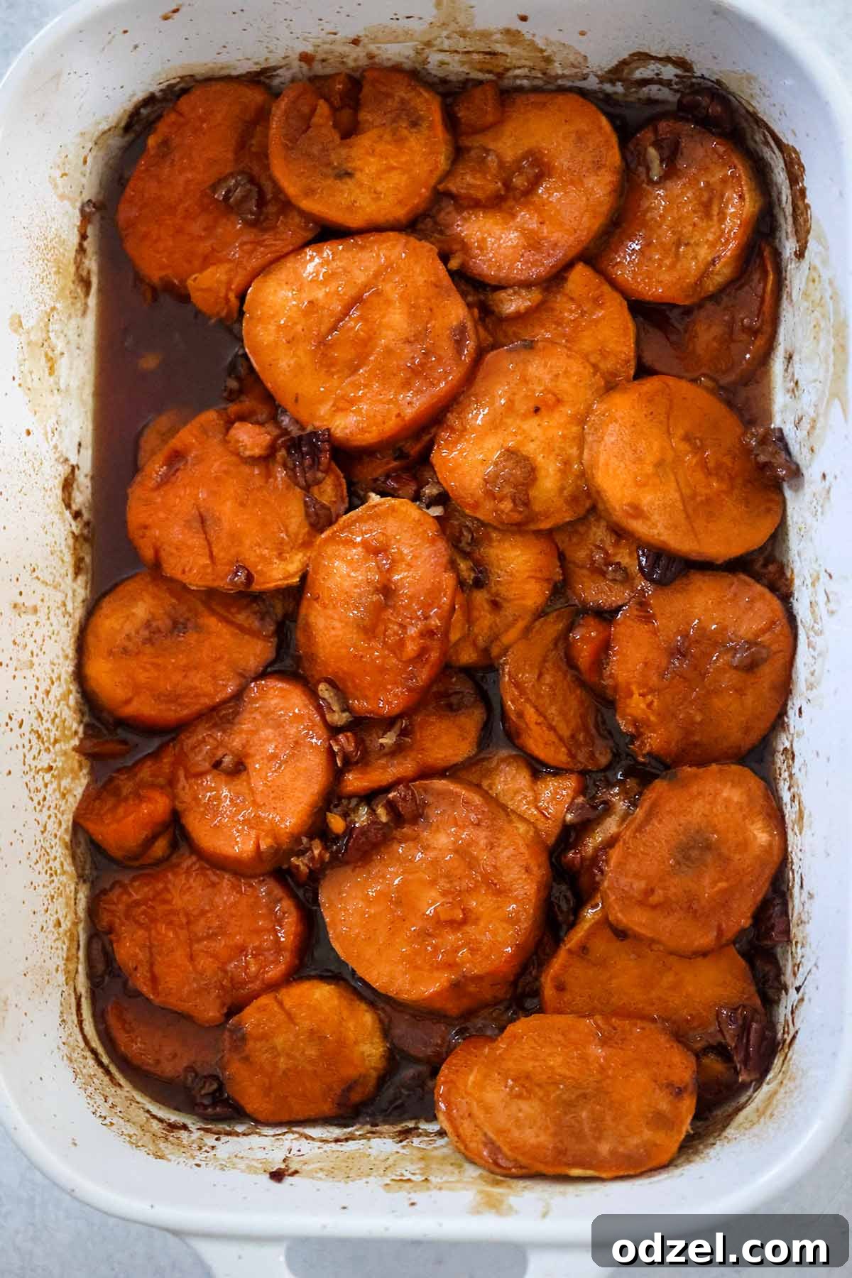 Caramelized Bourbon Yams 5 A festive white 9x13 casserole dish filled with beautifully baked bourbon candied yams, perfectly glazed and ready for a holiday meal presentation.