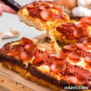 Detroit style pan pizza on a cutting board.