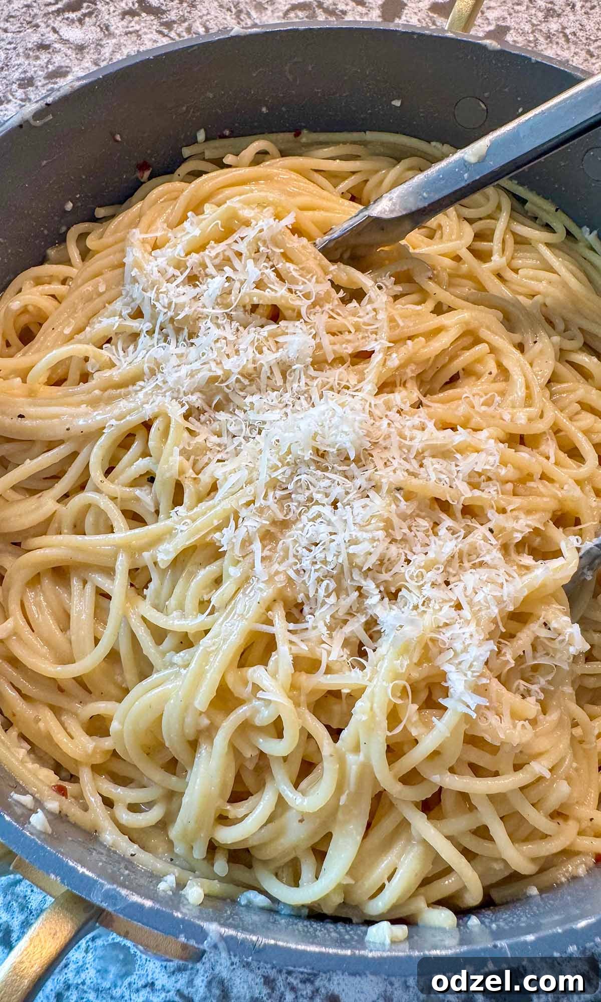 Golden Butter Noodles 4 Close-up shot of buttered noodles tossed with cheese and garlic, showcasing their creamy coating and delicious texture in a serving bowl.