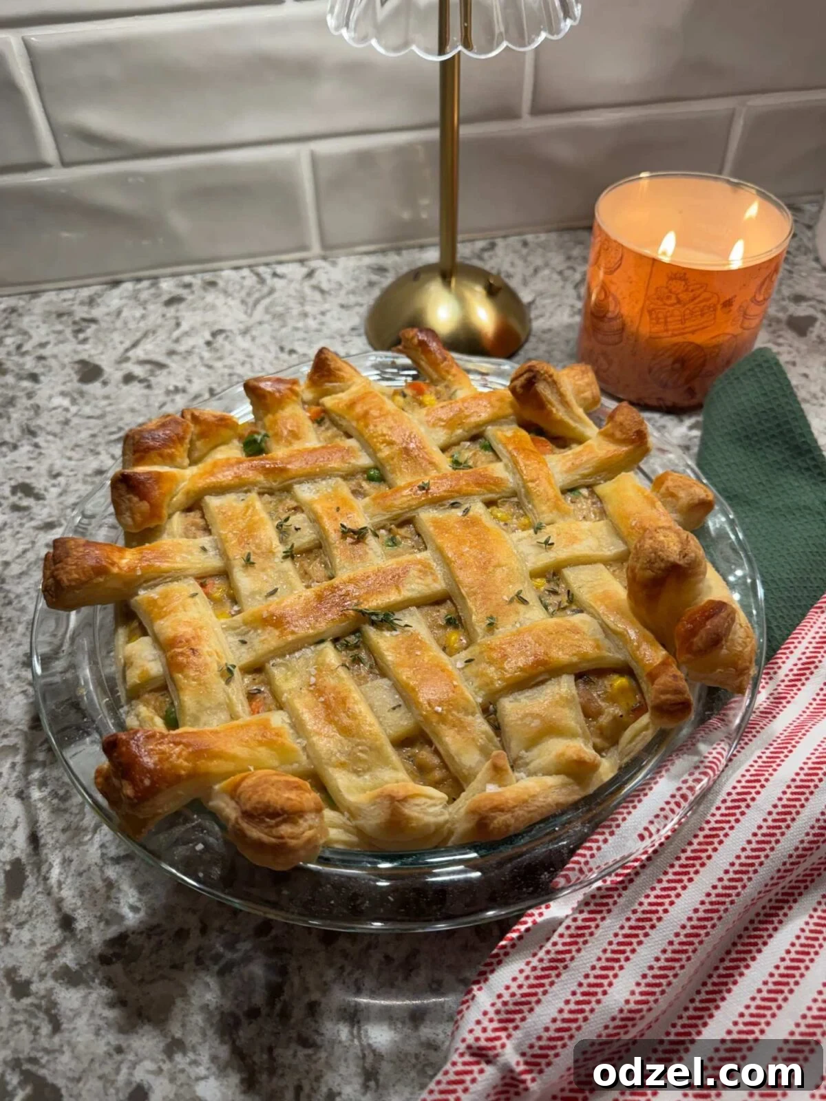 A delicious chicken pot pie with puff pastry in a 9-inch baking dish, perfectly golden brown and ready to be served.