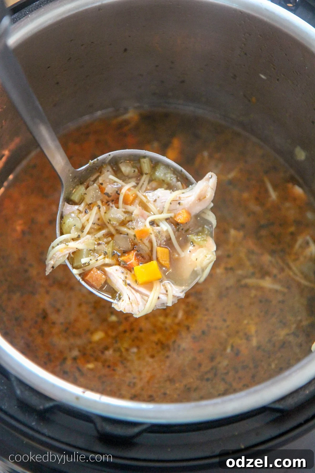 A large ladle scooping hearty chicken noodle soup from an Instant Pot, showcasing the rich broth, tender chicken, and vegetables.