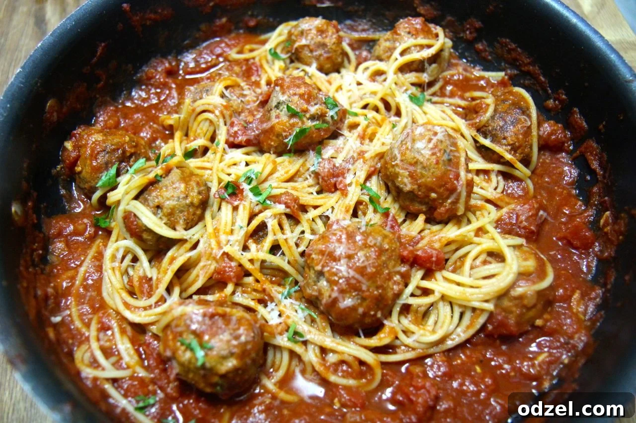 Delicious spicy spaghetti and meatballs served in a rustic bowl, ready to be enjoyed.