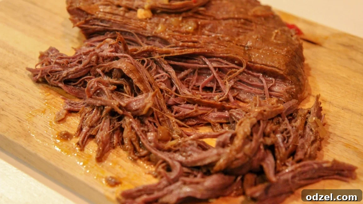 Perfectly shredded flank steak, pulled apart into tender strands, ready to be reunited with the flavorful sauce.