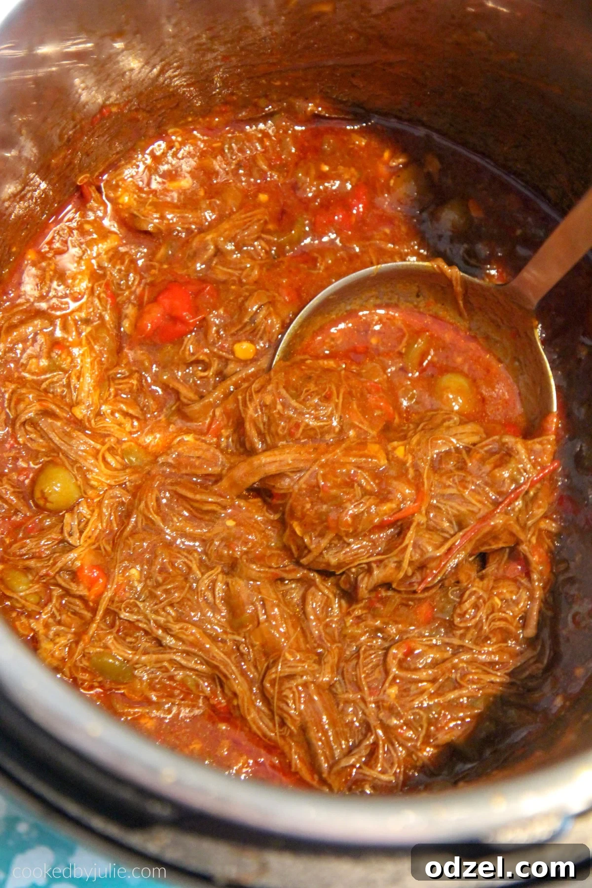 Shredded flank steak simmering in a rich, vibrant tomato broth with bell peppers and onions, a perfect Cuban stew.
