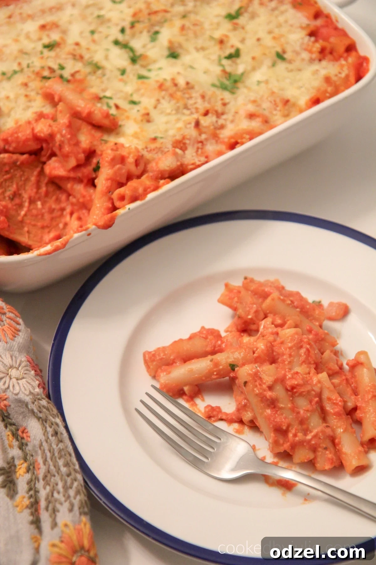Ultimate Cheesy Baked Ziti 3 A close-up of a plate of baked ziti with melted cheese and rich tomato sauce, ready to be enjoyed.