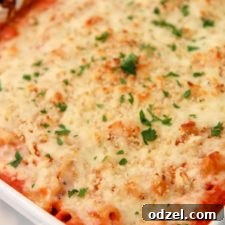 Ultimate Cheesy Baked Ziti 4 Olive garden baked ziti in a white casserole dish with fresh parsley on top