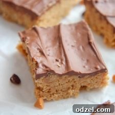 scotcharoos on parchment paper with chocolate chips and butterscotch chips