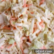 a closeup of creamy coleslaw in a bowl, showcasing its texture and freshness