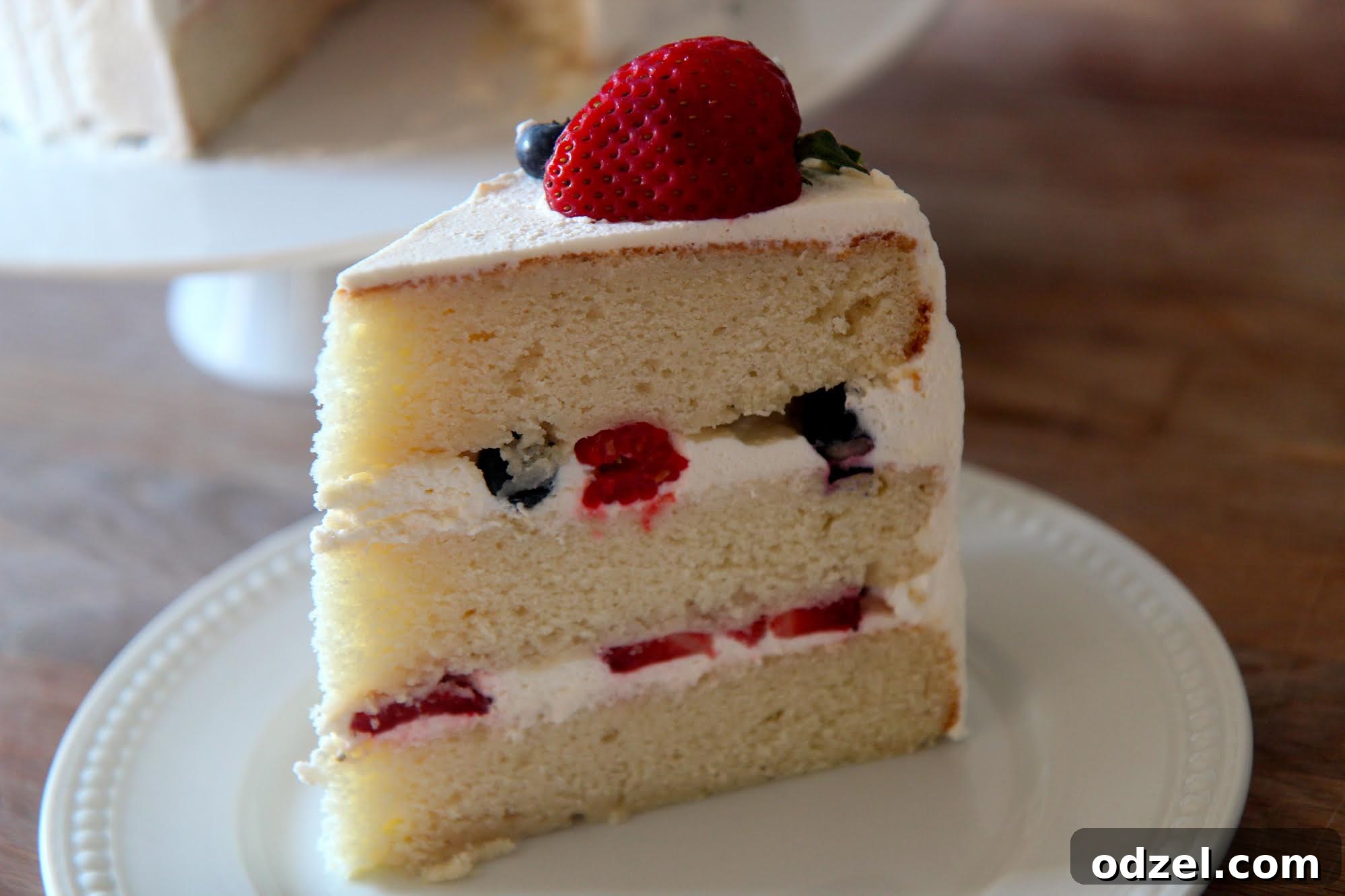 Summer Berry Symphony Cake 3 Three layers of yellow cake with a sweet vanilla frosting and filled with raspberries, strawberries, and blueberries