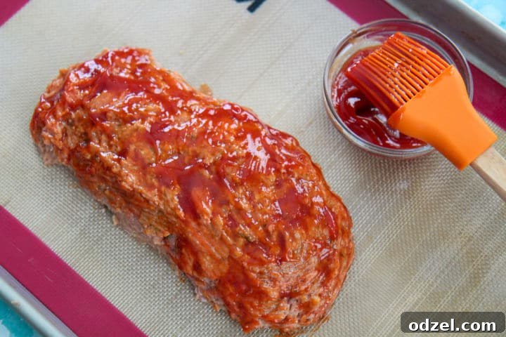turkey meatloaf with a ketchup glaze on a baking sheet