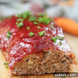 turkey meatloaf with parsley on top on a wooden board