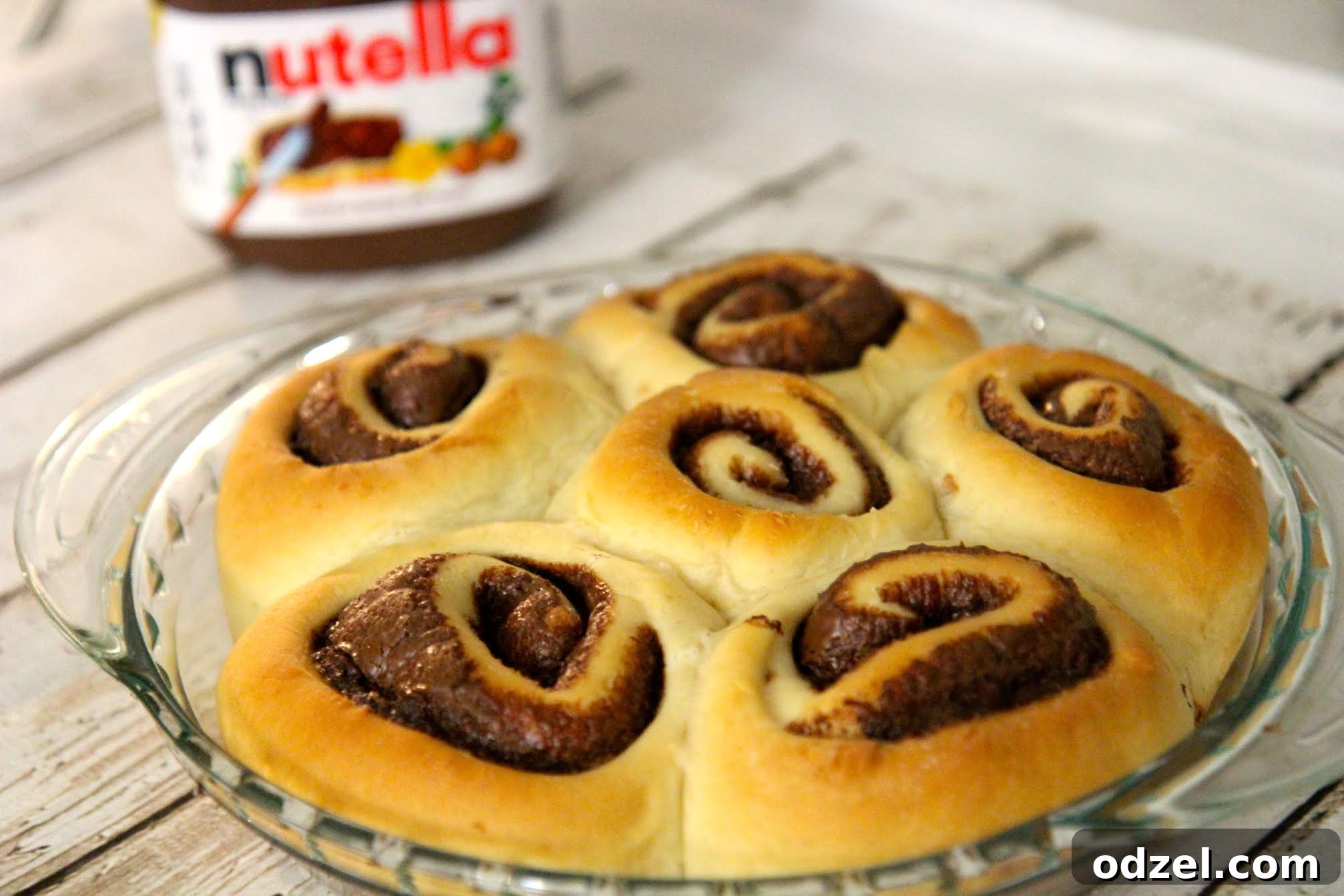 Nutella Swirl Cinnamon Rolls From Scratch 3 Soft and gooey homemade cinnamon rolls filled with Nutella, showcasing a close-up of the rich, melted chocolate hazelnut filling