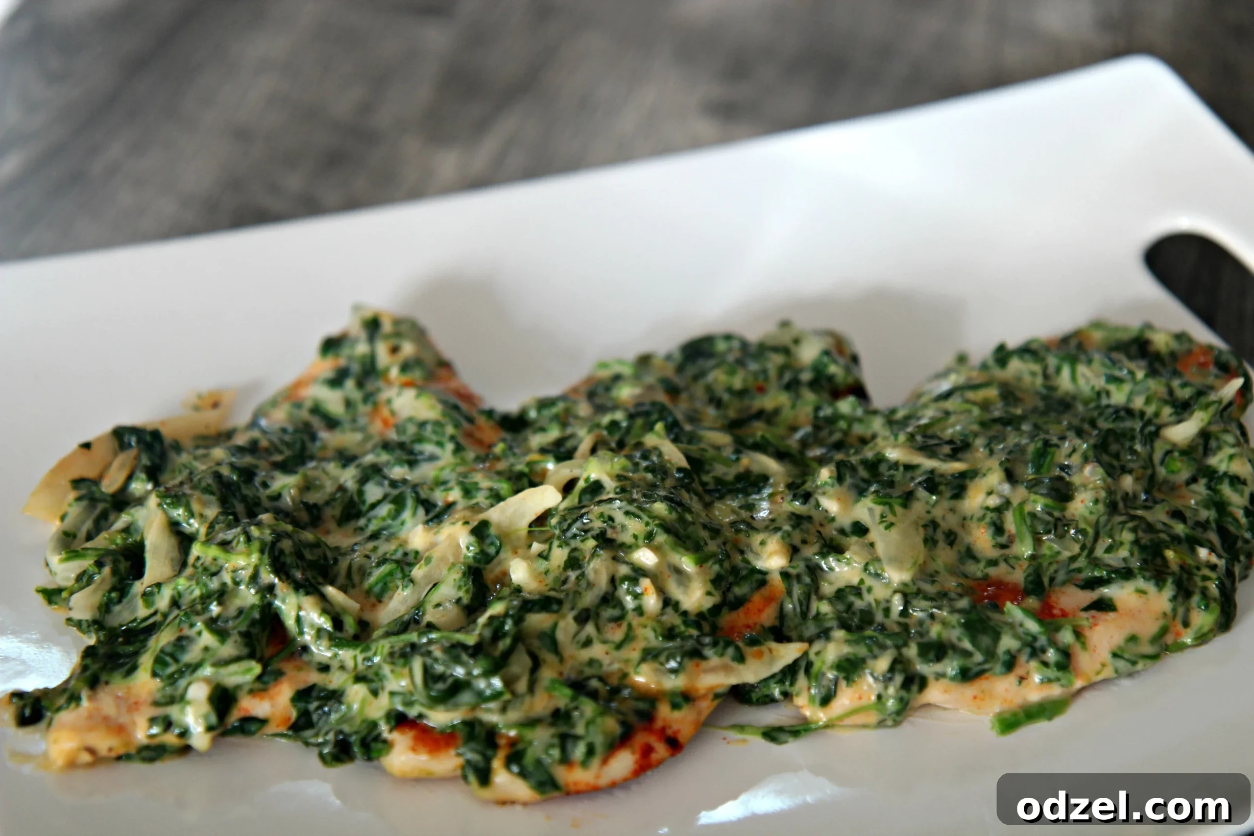 Tender and juicy chicken breast generously topped with a delectable creamed spinach mixture