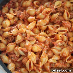 beef and shells in a large black skillet