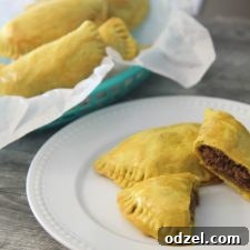 Jamaican beef patties in a basket and a white plate