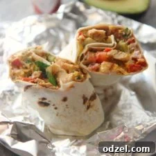 tex mex grilled chicken burrito on aluminum foil.