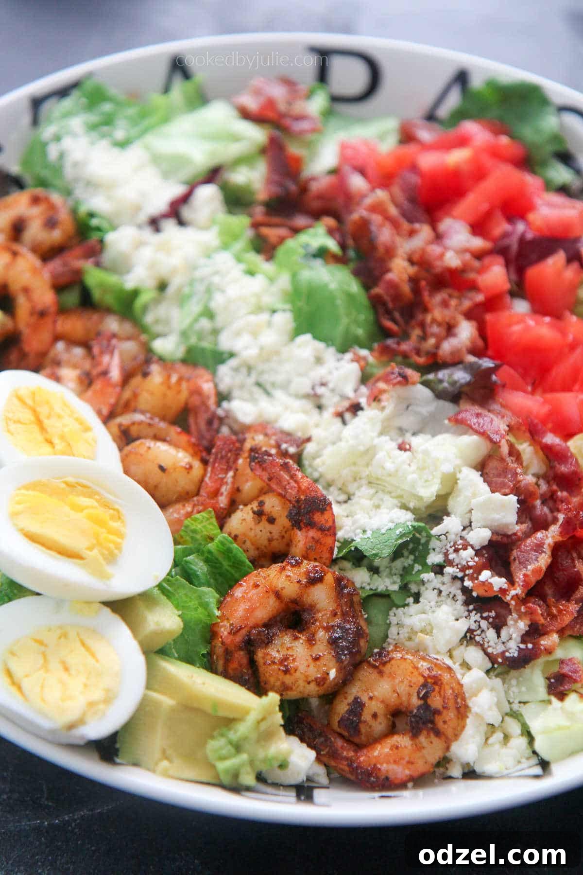 Vibrant Shrimp Cobb 2 shrimp cobb salad with boiled eggs in a white plate