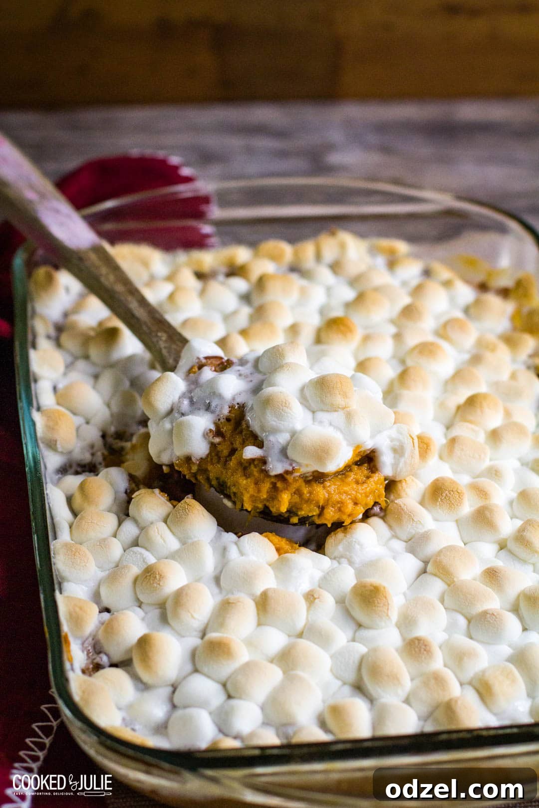 Golden Sweet Potato Bliss 2 Irresistible sweet potato casserole in a baking dish, ready to be served with a wooden spoon