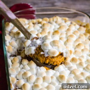 sweet potato casserole in a baking dish with wooden spoon
