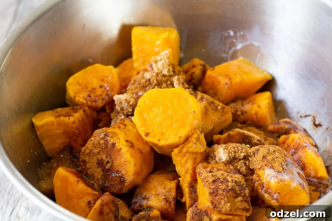 Golden Sweet Potato Bliss 4 Mashed sweet potatoes with milk, butter, brown sugar, and spices in a stainless steel bowl