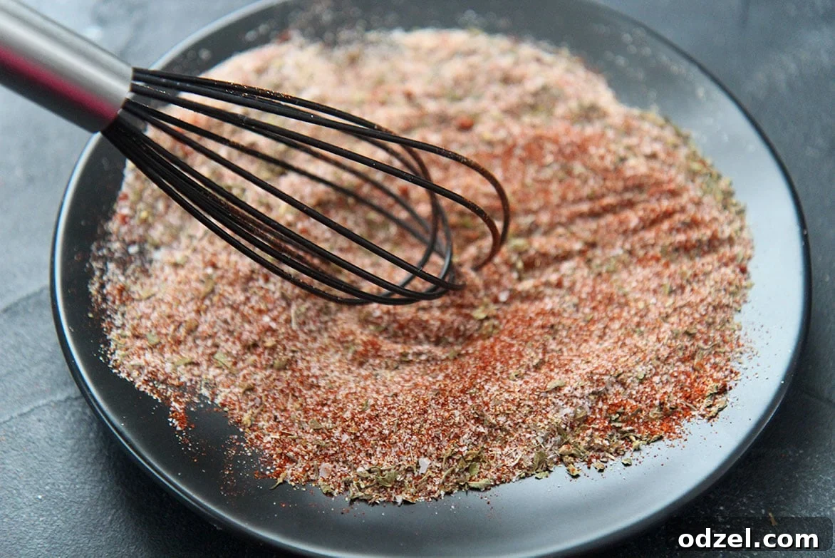 Louisiana's Fiery Spice Blend 4 Freshly combined Cajun seasoning blend on a black plate, ready to be stored
