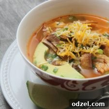 A vibrant bowl of Spicy Chicken Tortilla Soup, ready to be enjoyed.