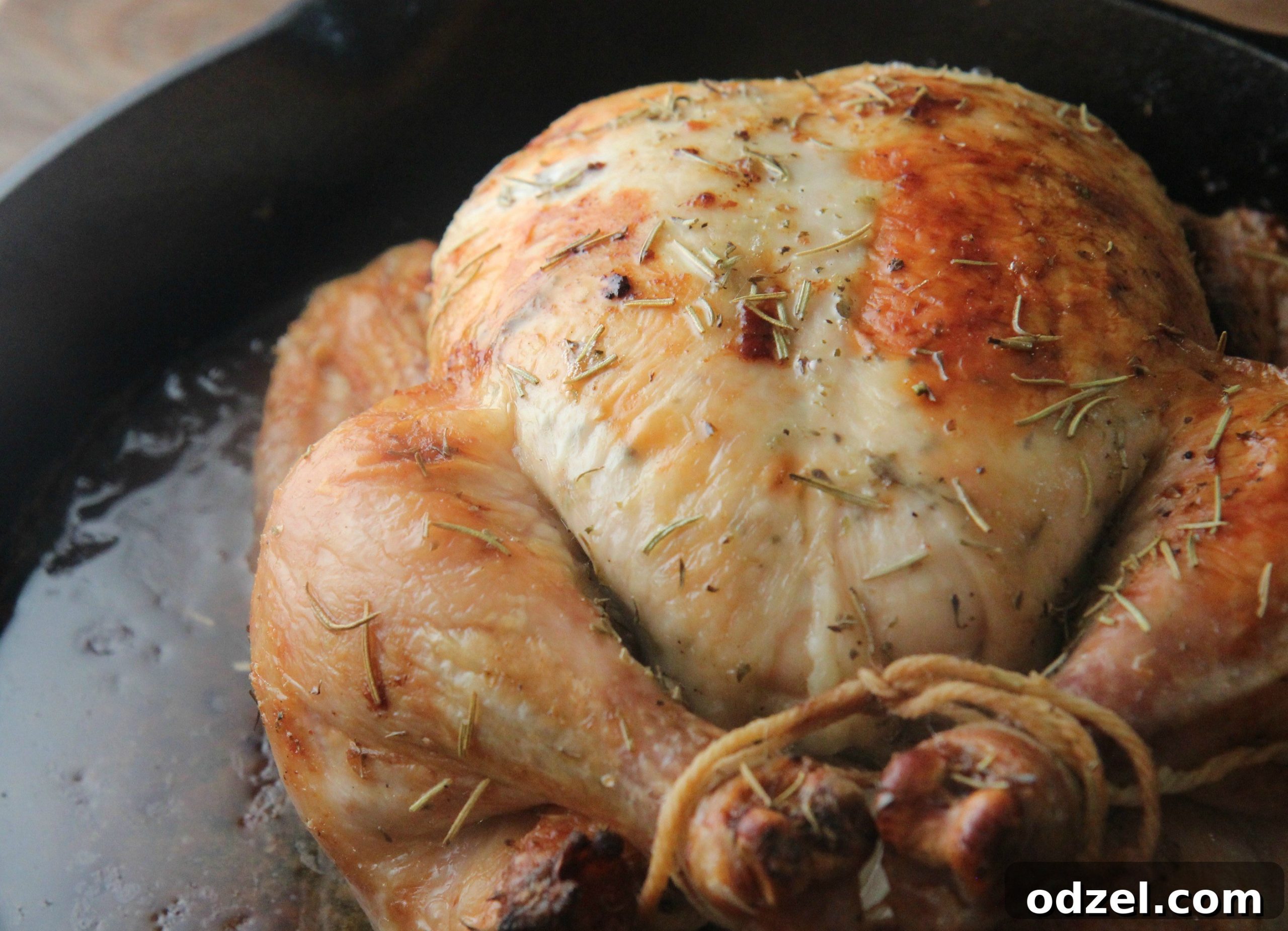 A perfectly roasted whole chicken on a carving board, showcasing its golden, crispy skin and the juicy meat inside, ready to be served as a delicious and satisfying meal.