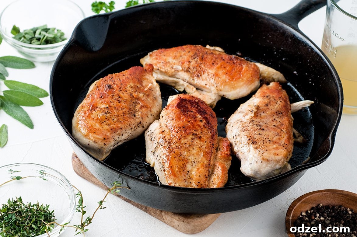 Savory Garlic Chicken with Spaghetti Squash 4 Four cooked chicken breasts searing in an iron skillet, creating a delicious crust.