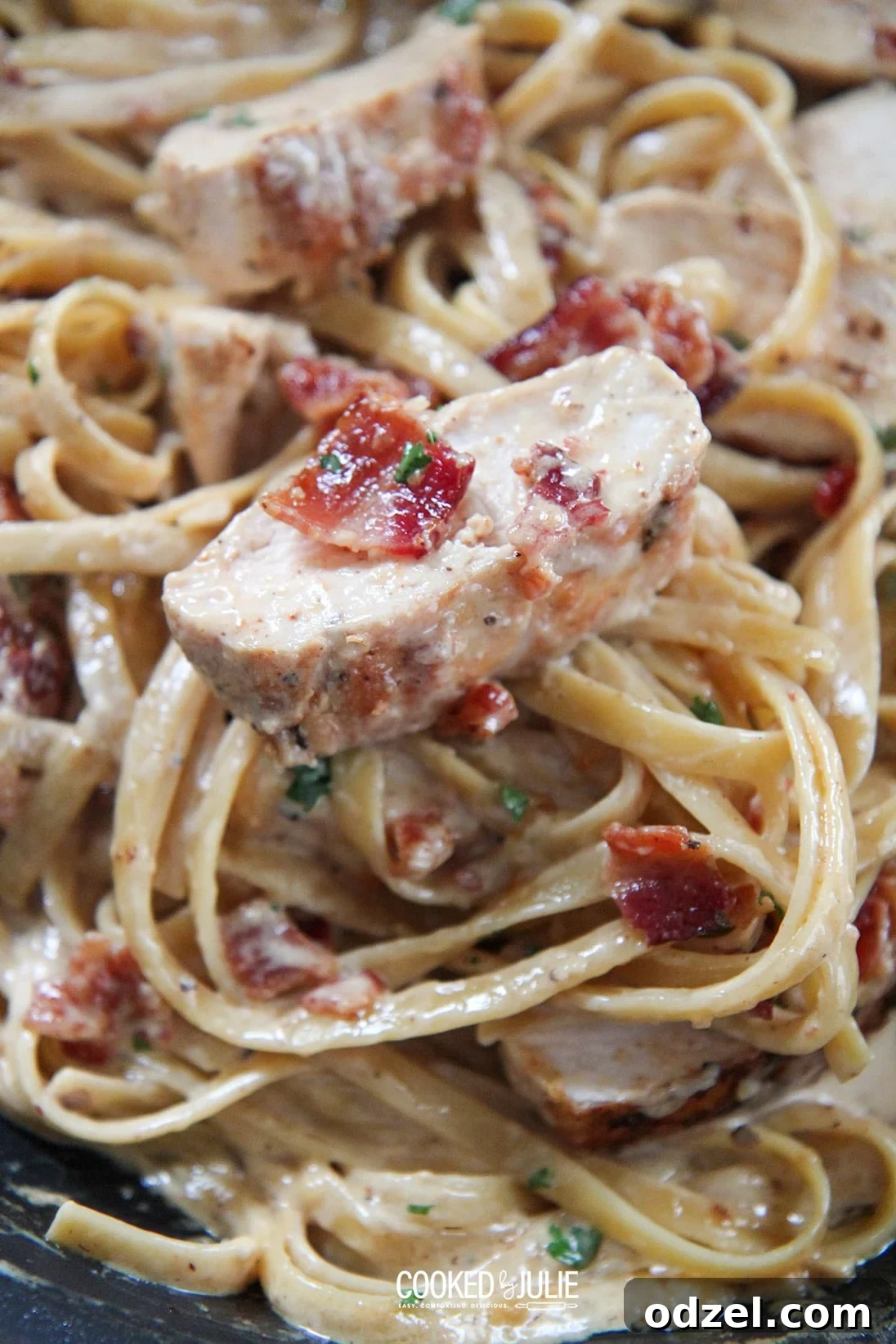 Close-up of creamy chicken and bacon fettuccine, showcasing the rich sauce and perfectly cooked ingredients.