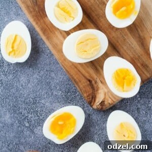 scattered boiled egg halves with a pinch bowl of salt and pepper