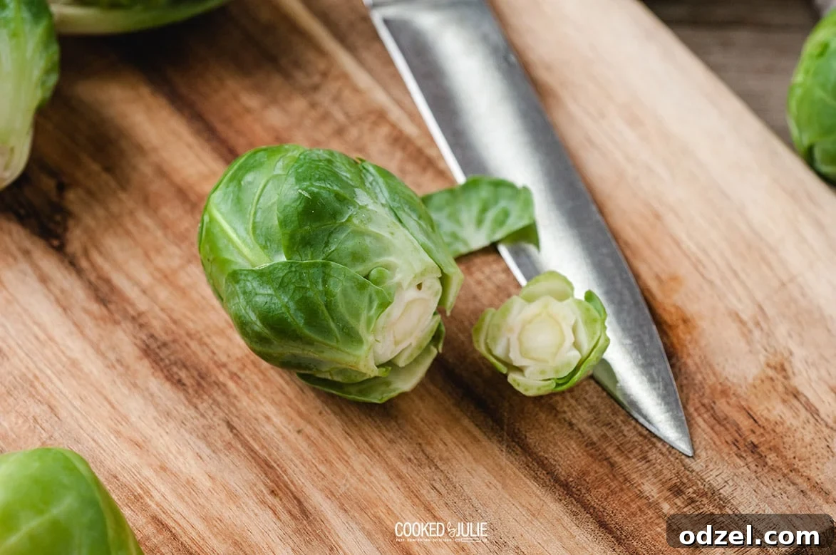 brussel sprouts on a wooden board with a knife