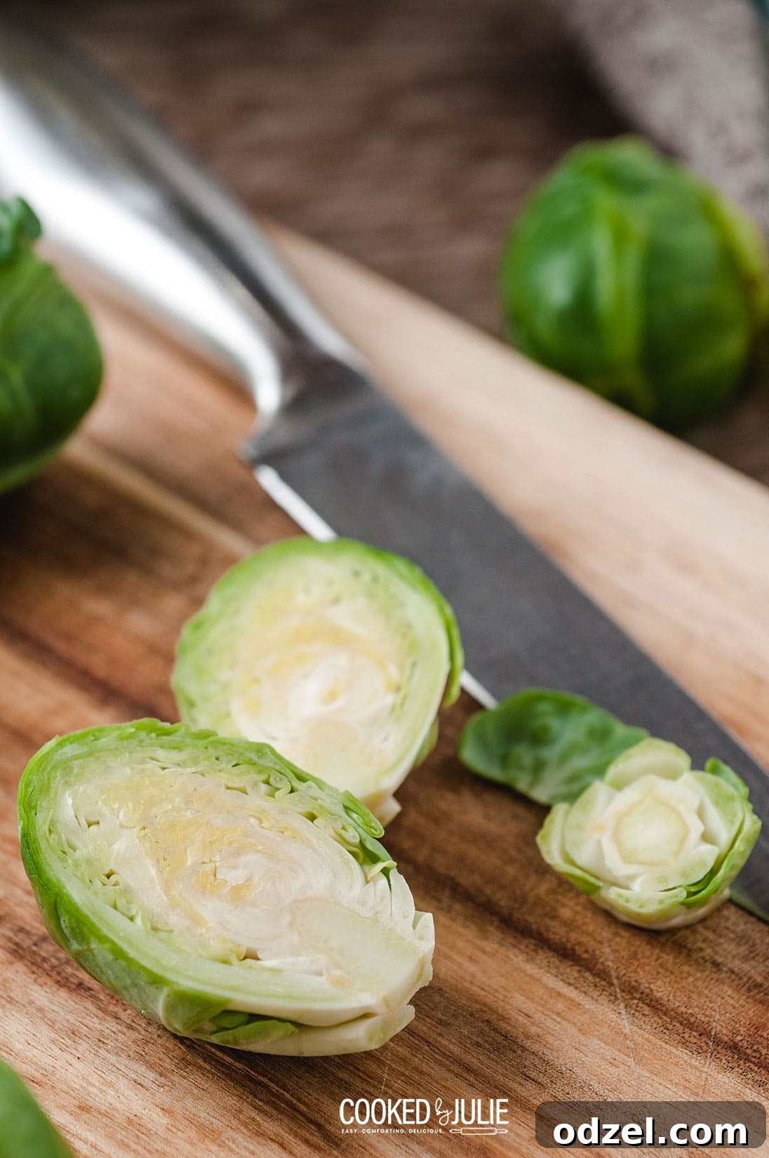 brussel sprouts sliced in half on a wooden board
