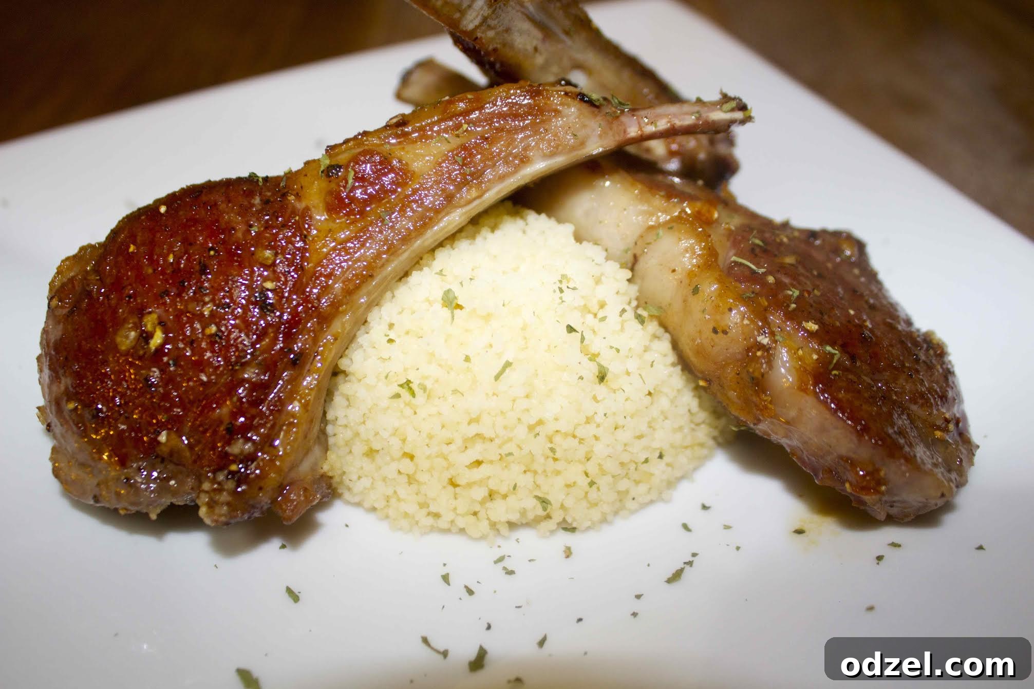 The savory spice blend and the sweet honey garlic glaze for lamb chops, served over couscous